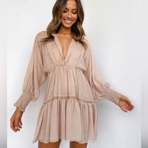 V-neckline dress framed with lace detailing, puffy sleeves